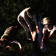Four dancers laying in the grass