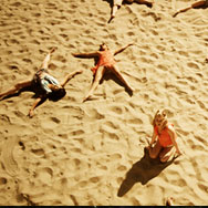 Dancers laying on a beach spread out for shoot